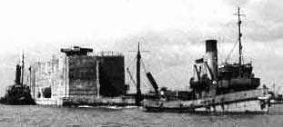 Tugs towing concrete breakwaters to Normandy