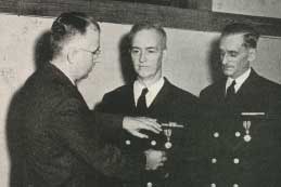 Ralph E. Jamieson receives DSM medal while William R. Rudolph looks on