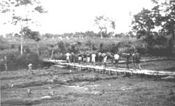 Funeral procession crossing the creek