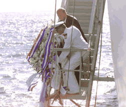 Ed Melis dropping wreath into sea