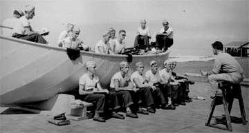 Merchant Marine Officer teaching lifeboat skills to the Army crewmembers