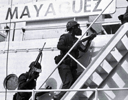 Marines wearing gas masks board the SS Mayaguez