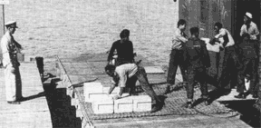 African-American Navy enlisted men unloading ammunition